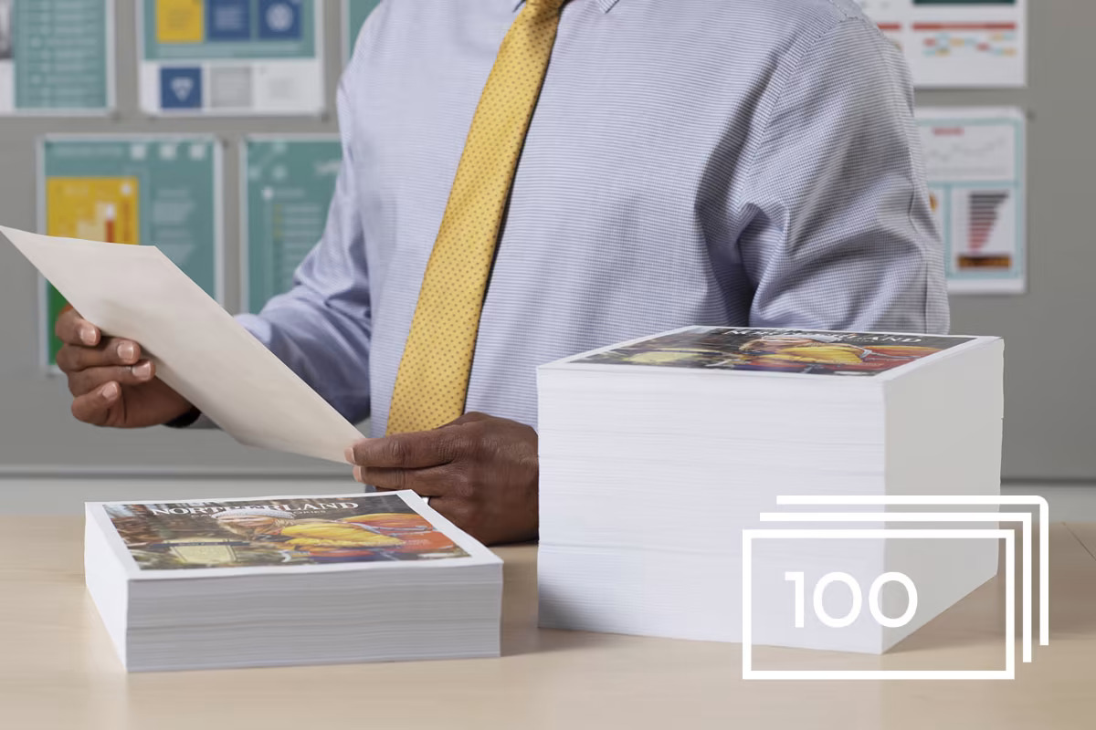 man-reviewing-large-stack-of-printouts-1200x800